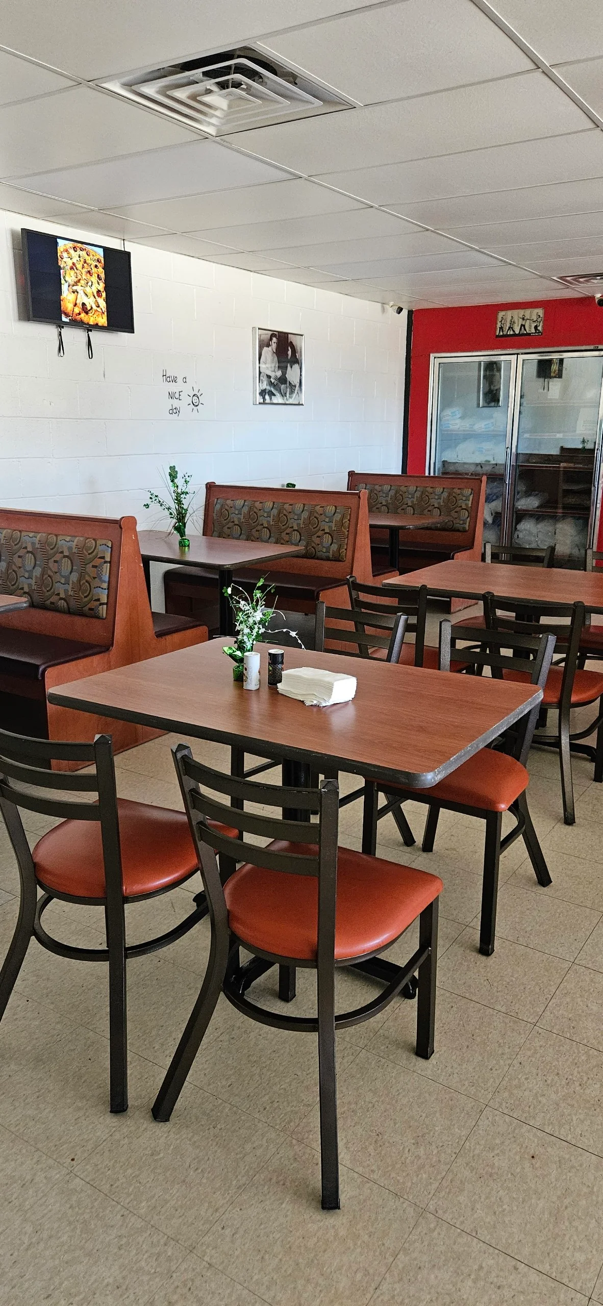 Cozy dining area with wooden tables and warm lighting in a restaurant.