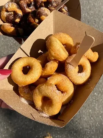 Freshly made mini donuts dusted with sugar