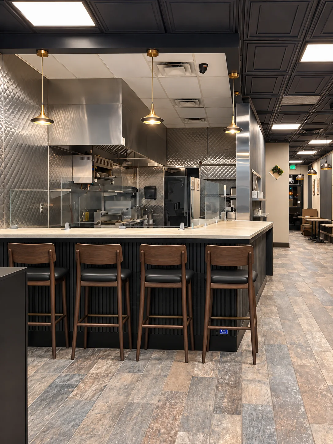 Modern restaurant kitchen with bar seating and stylish lighting