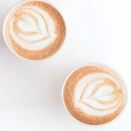 Artisan cappuccinos with latte art designs