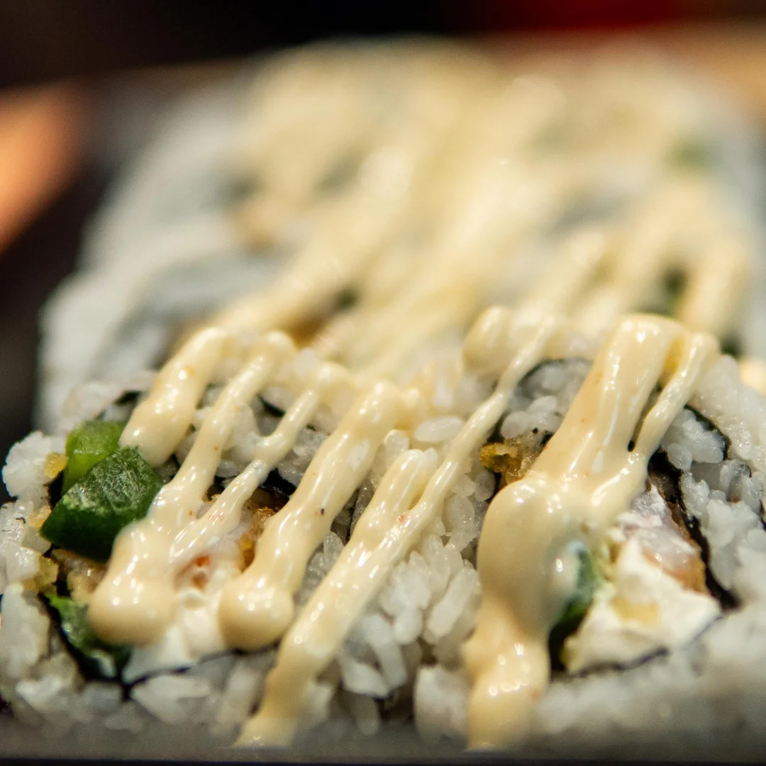 Japanese sushi roll drizzled with creamy sauce