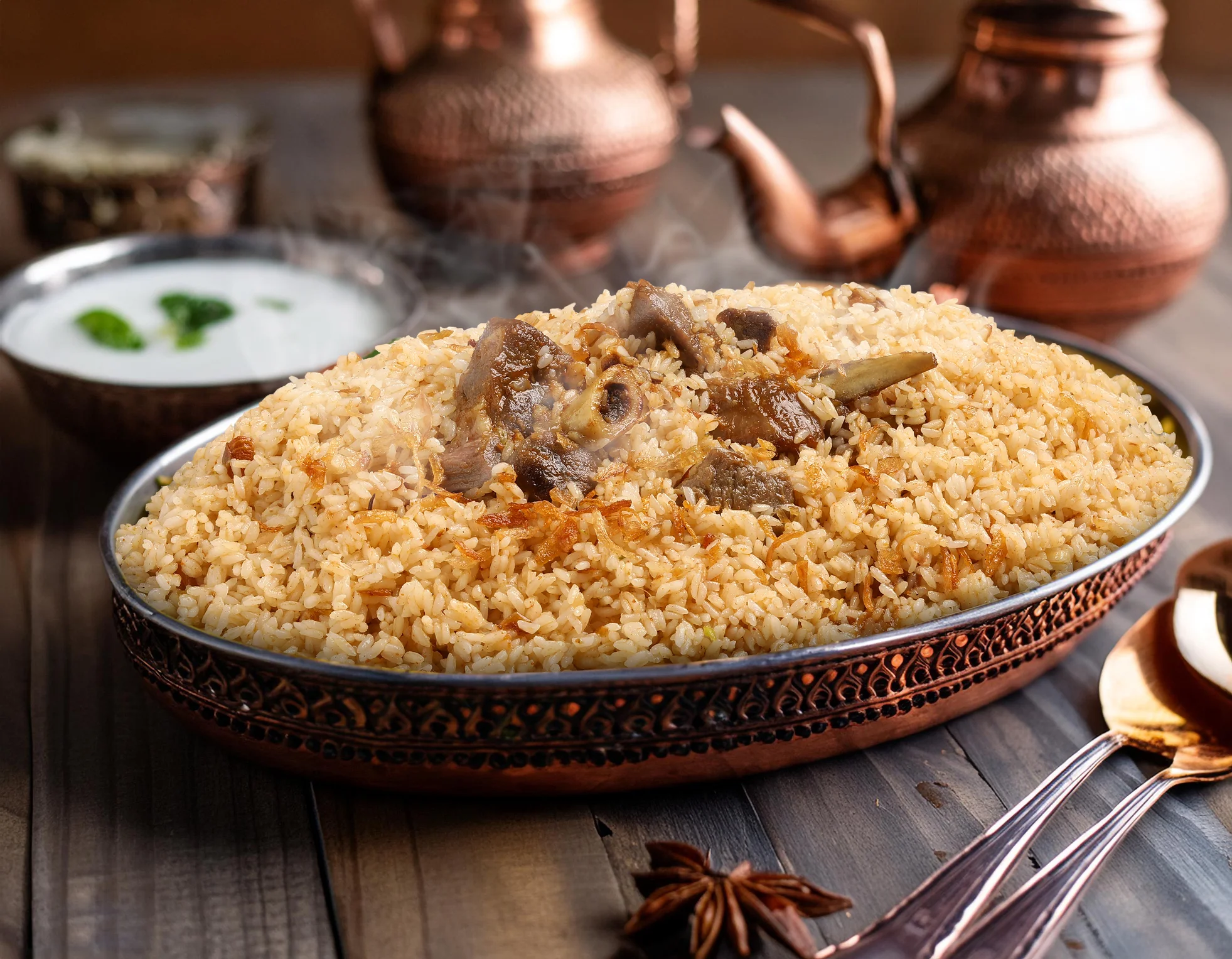 Traditional Pakistani biryani served with yogurt sauce