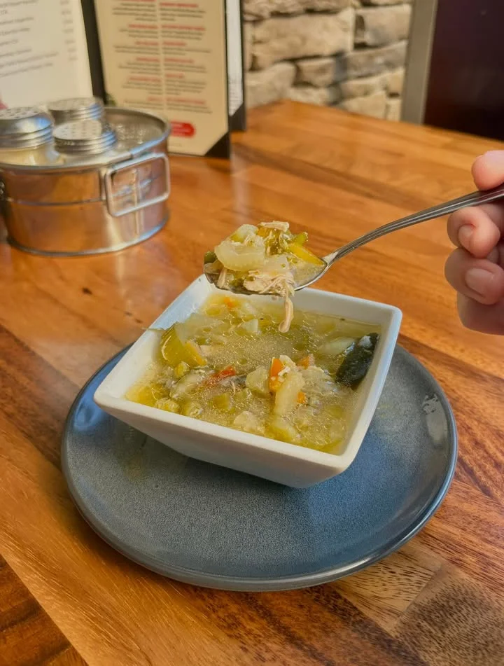 Bowl of comforting chicken soup with vegetables