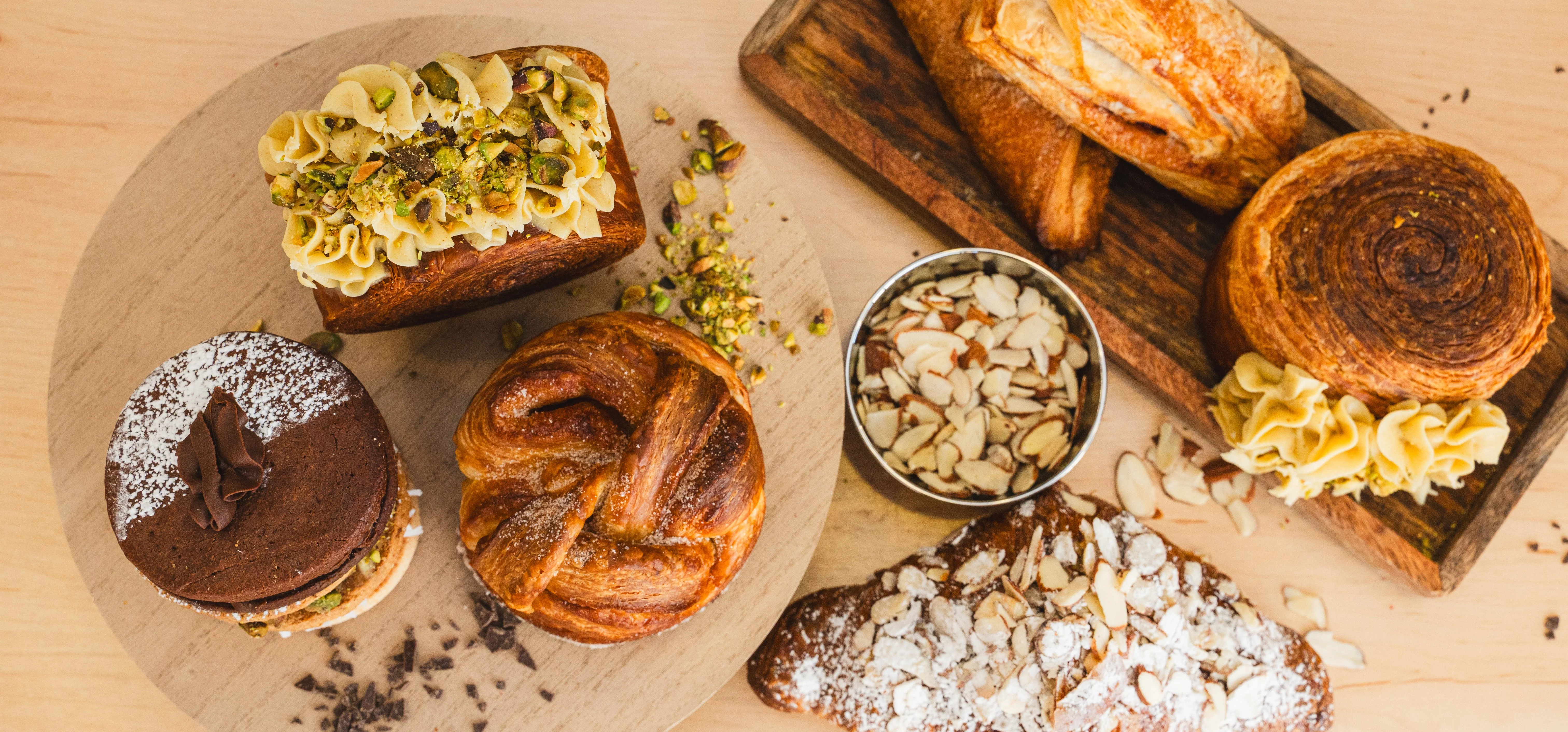 Assorted French pastries including croissants and éclairs