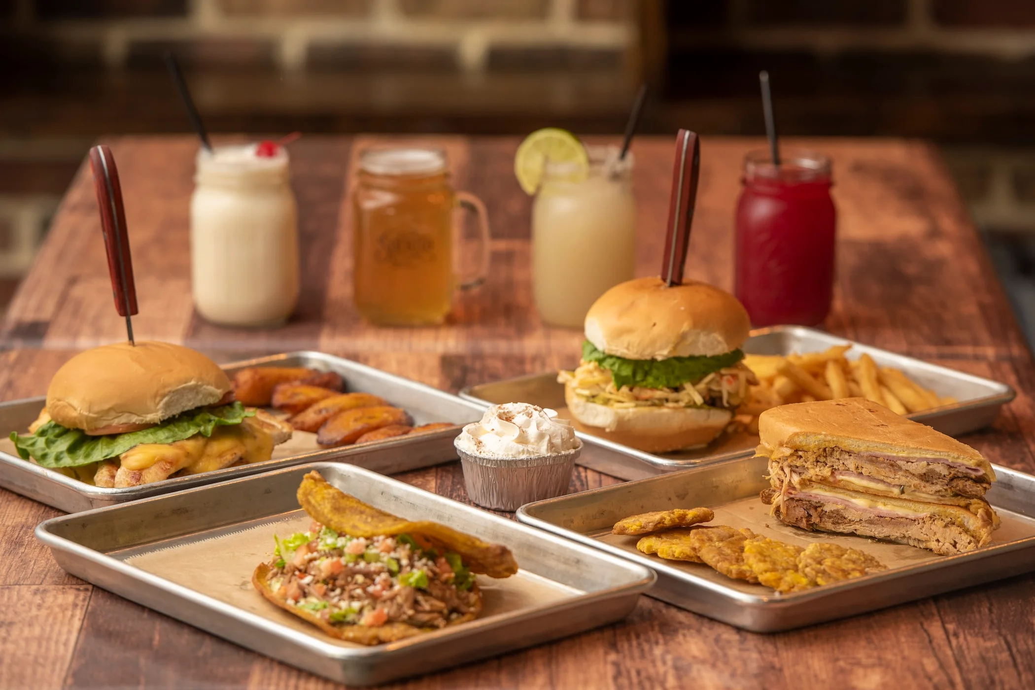 Delicious Cuban sandwich with sides and drinks in a vibrant restaurant setting