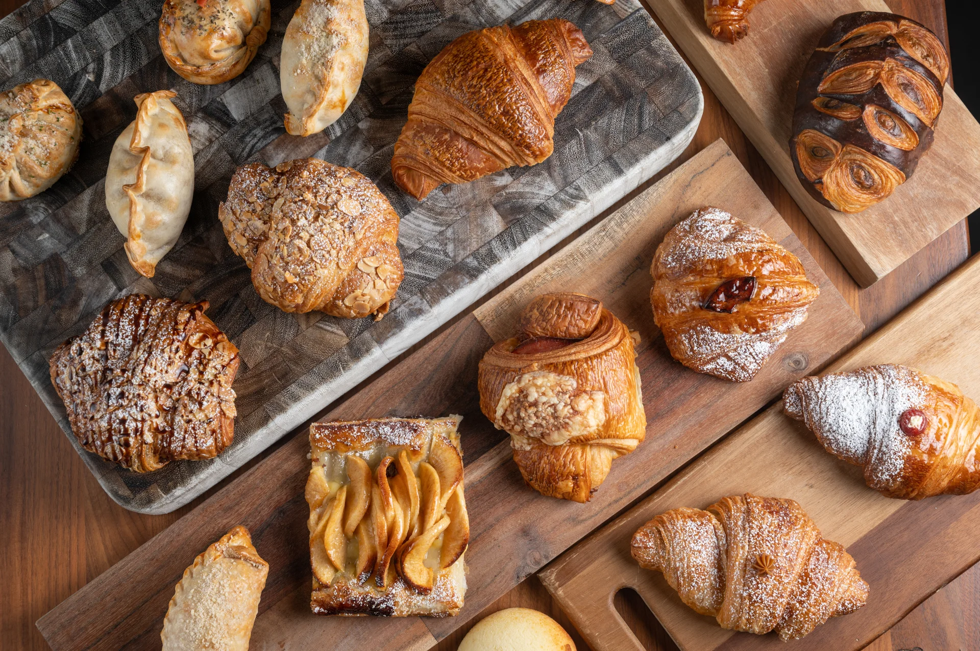 Assorted French pastries on wooden boards