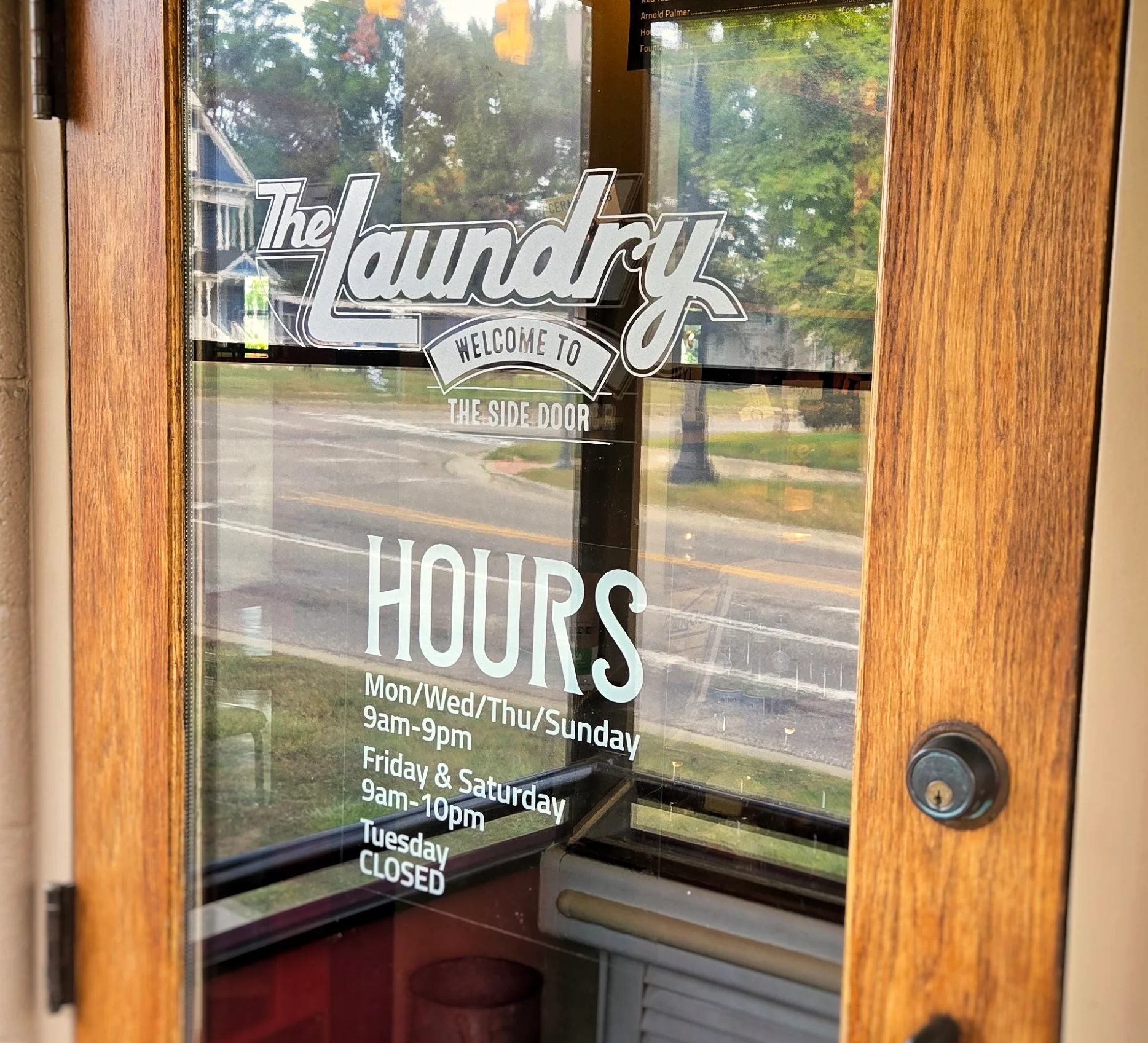 Entrance of The Laundry restaurant with hours displayed