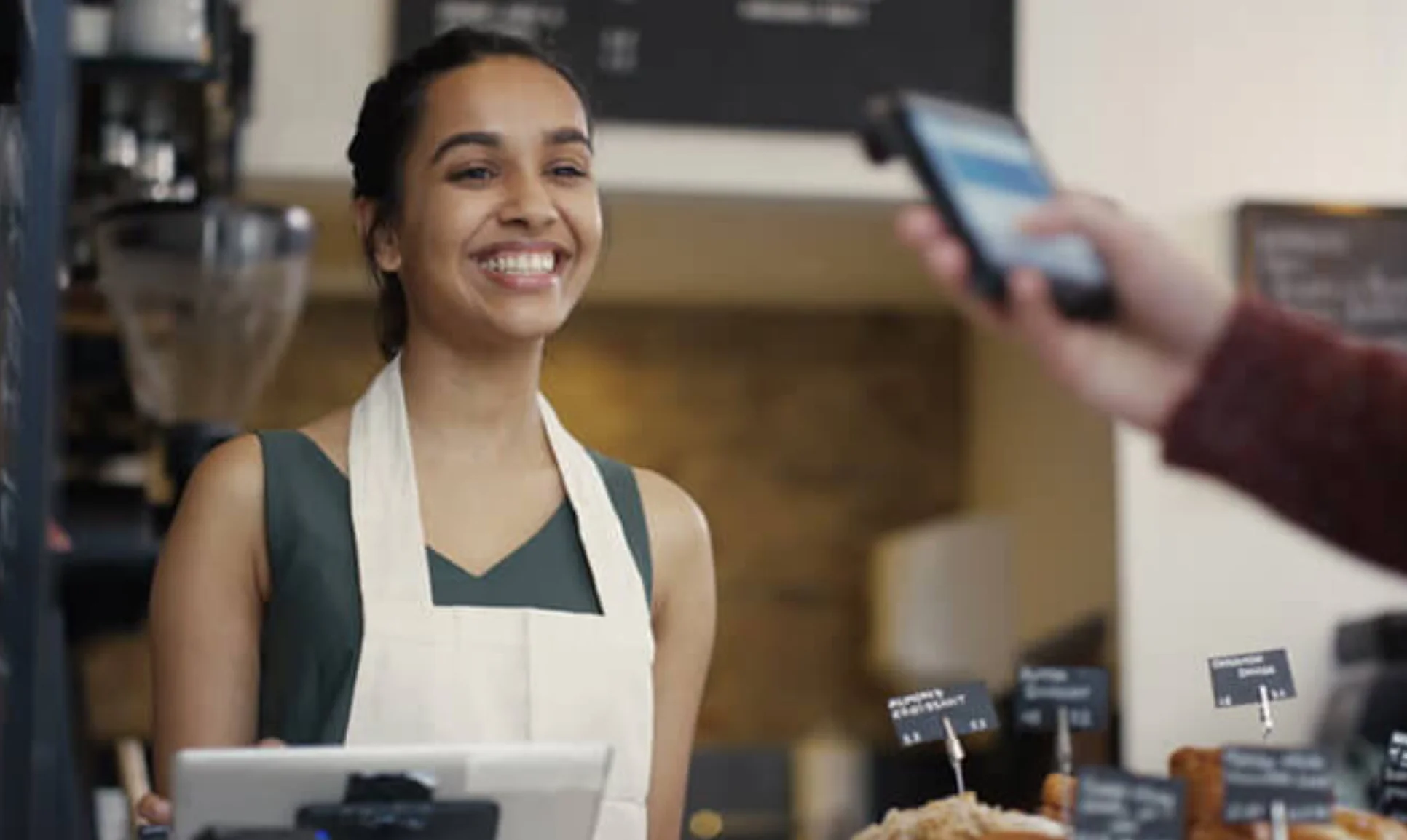 Cashier providing customer service at Tolex