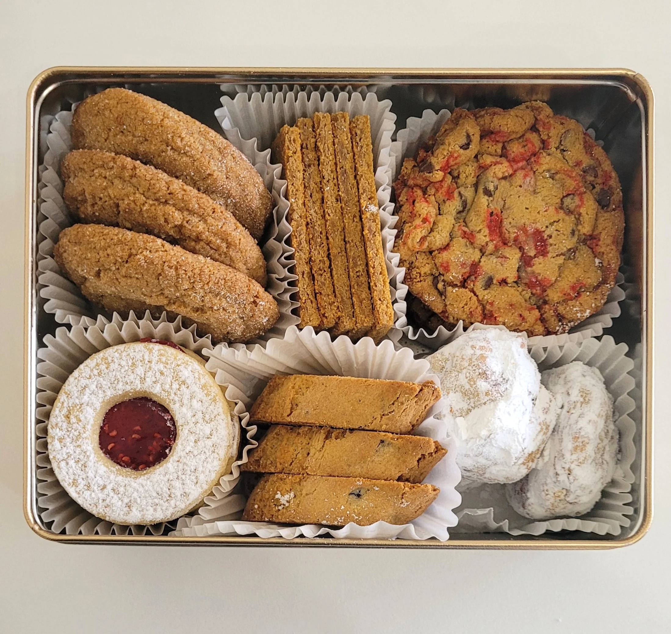 Assorted European cookies and pastries in a decorative gift tin