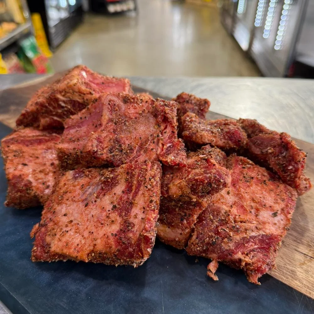 Smoked brisket burnt ends on a wooden platter