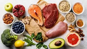 An assortment of fresh foods including fruits, vegetables, and meats.