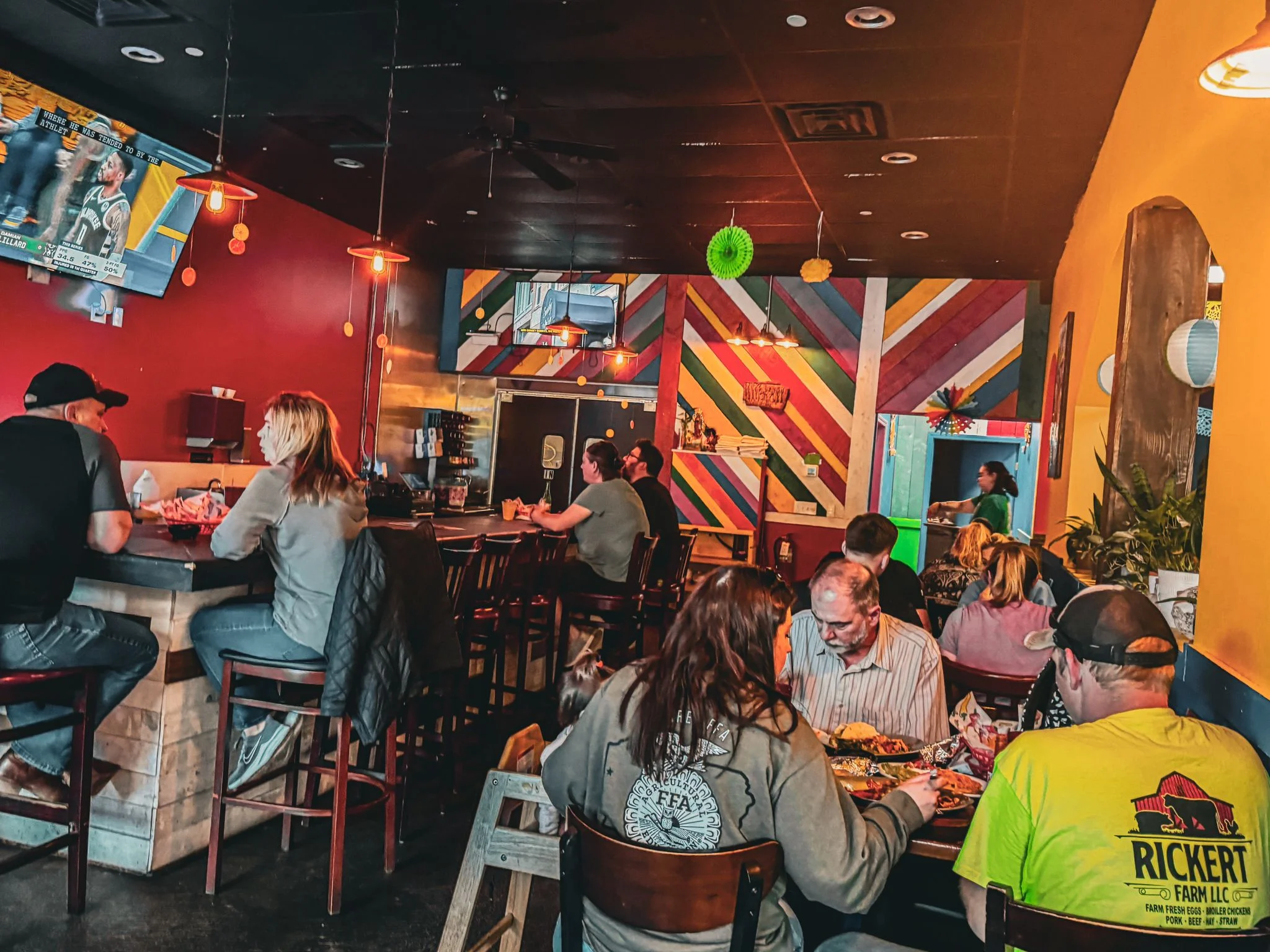 Vibrant restaurant interior with colorful decor and patrons enjoying meals
