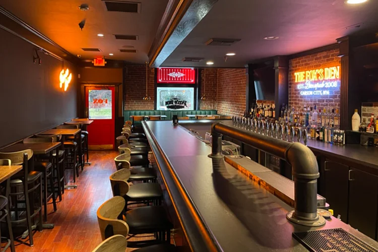 Spacious bar and seating area in The Fox's Den, Carson City's hidden gem at The Fox Restaurant & Brewery—complete with draft taps, large TVs, and inviting non-smoking vibe since 2008