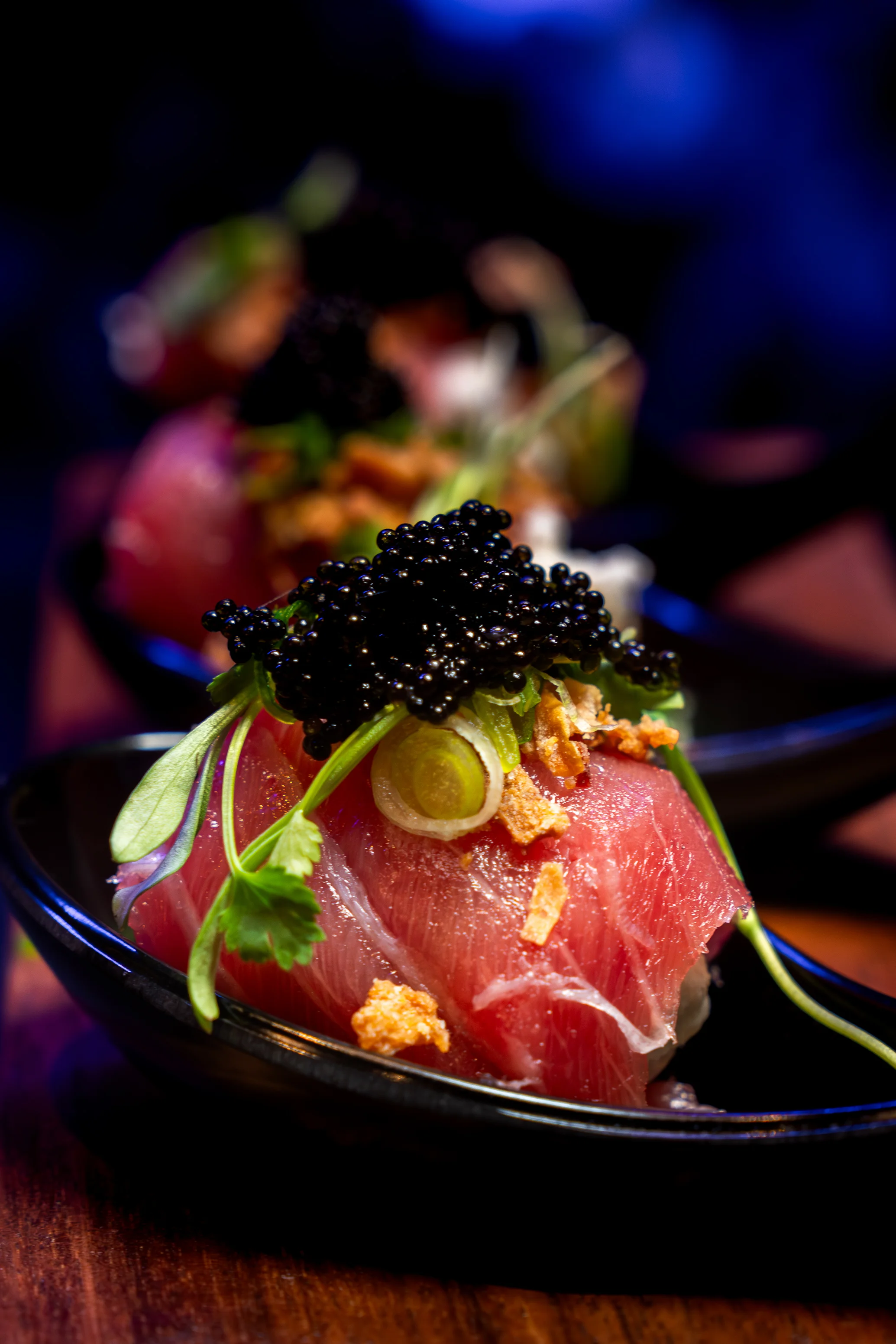 Japanese sushi with tuna and caviar garnished with herbs