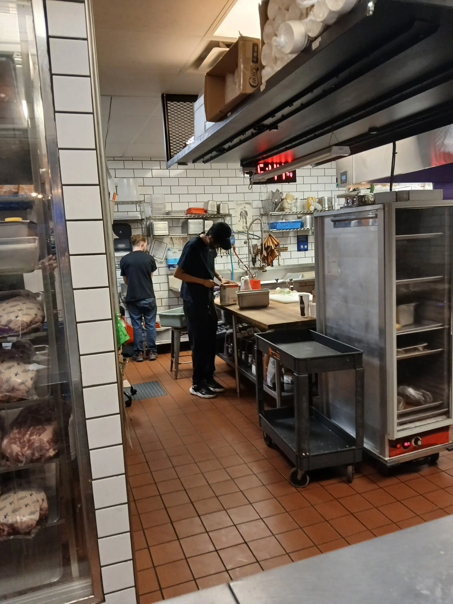 Busy restaurant kitchen with chefs preparing food