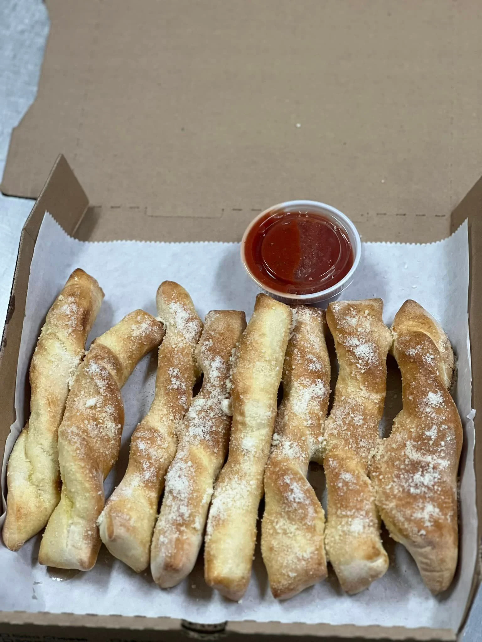 Garlic breadsticks served with marinara sauce