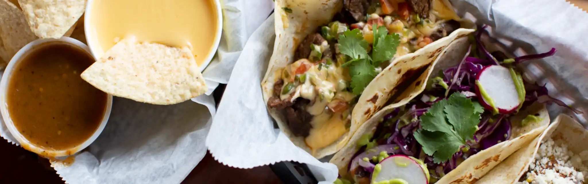 Brazos Tacos - Image of tacos, chips, salsa, and queso