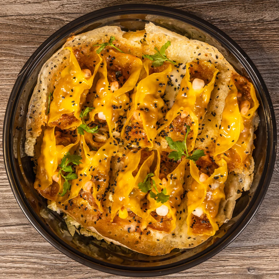 Delicious cheesy dumplings served on a crispy base with herbs.