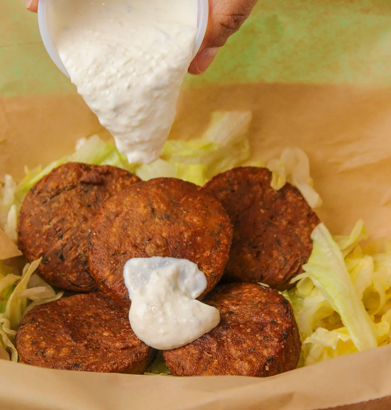 Sauce dripping on some mediterranean bites