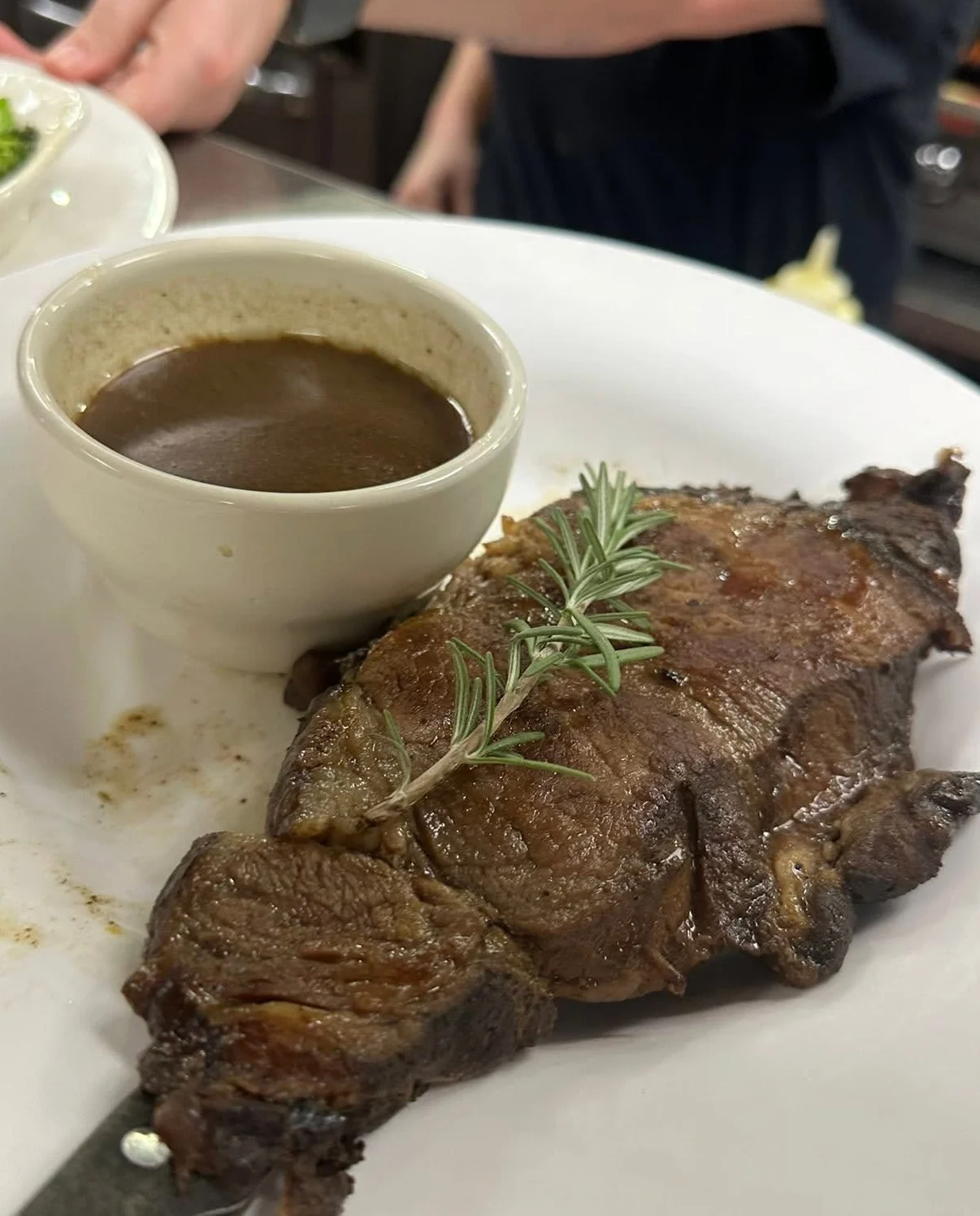Logo of Tennille's Steak & Seafood featuring flames and a cloche
