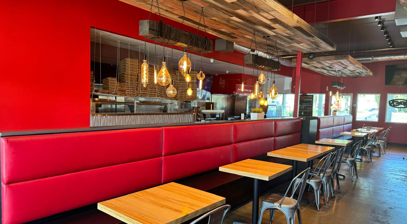 Modern restaurant interior with red walls and stylish lighting fixtures
