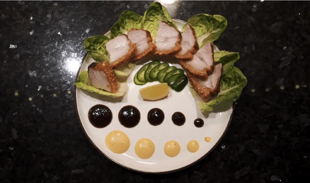 Sliced pork belly appetizer with lettuce, cucumber and sauce dots at Mahzu East Windsor