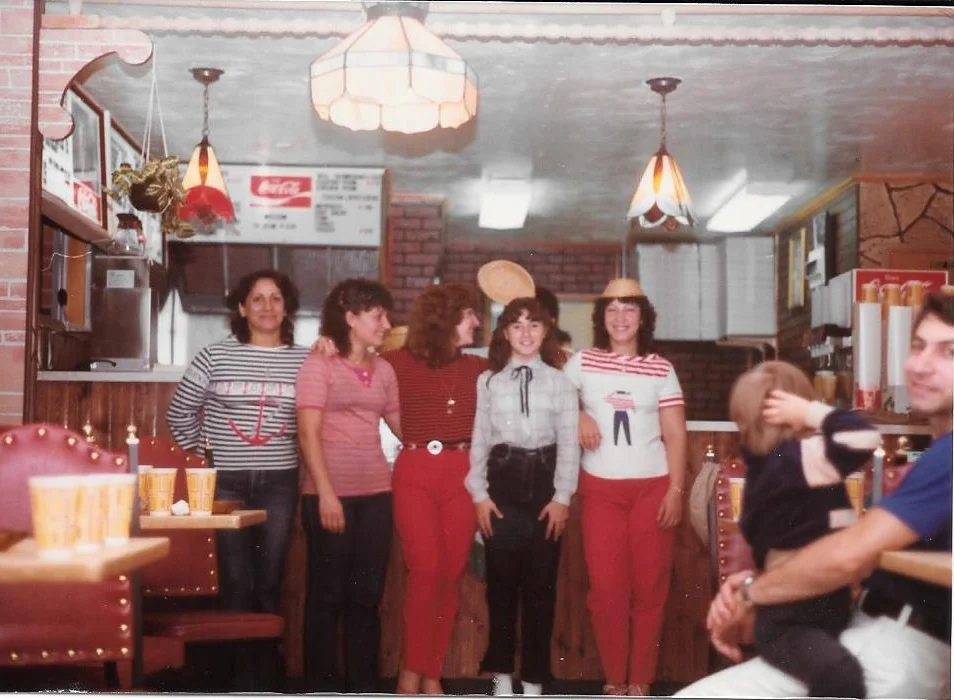 Vintage restaurant staff posing in a cozy diner setting