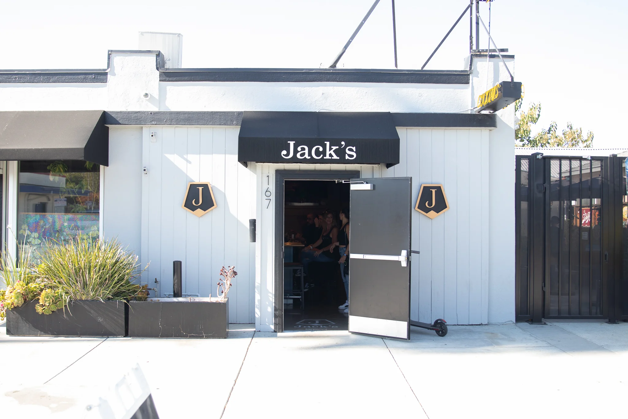 Exterior view of a modern restaurant with outdoor seating and vibrant decor.