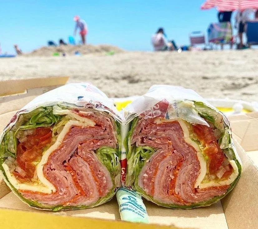 Italian sub sandwich with layers of meats and fresh vegetables