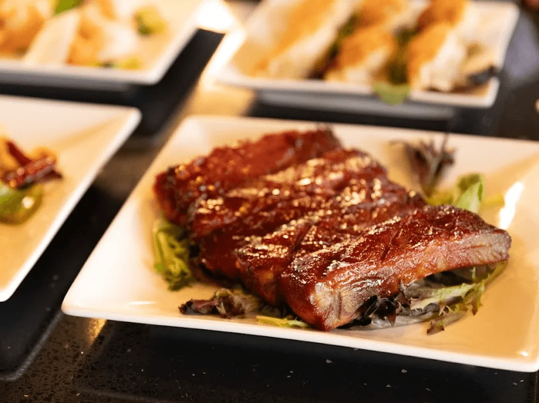 Grilled Korean BBQ short ribs served on a bed of greens
