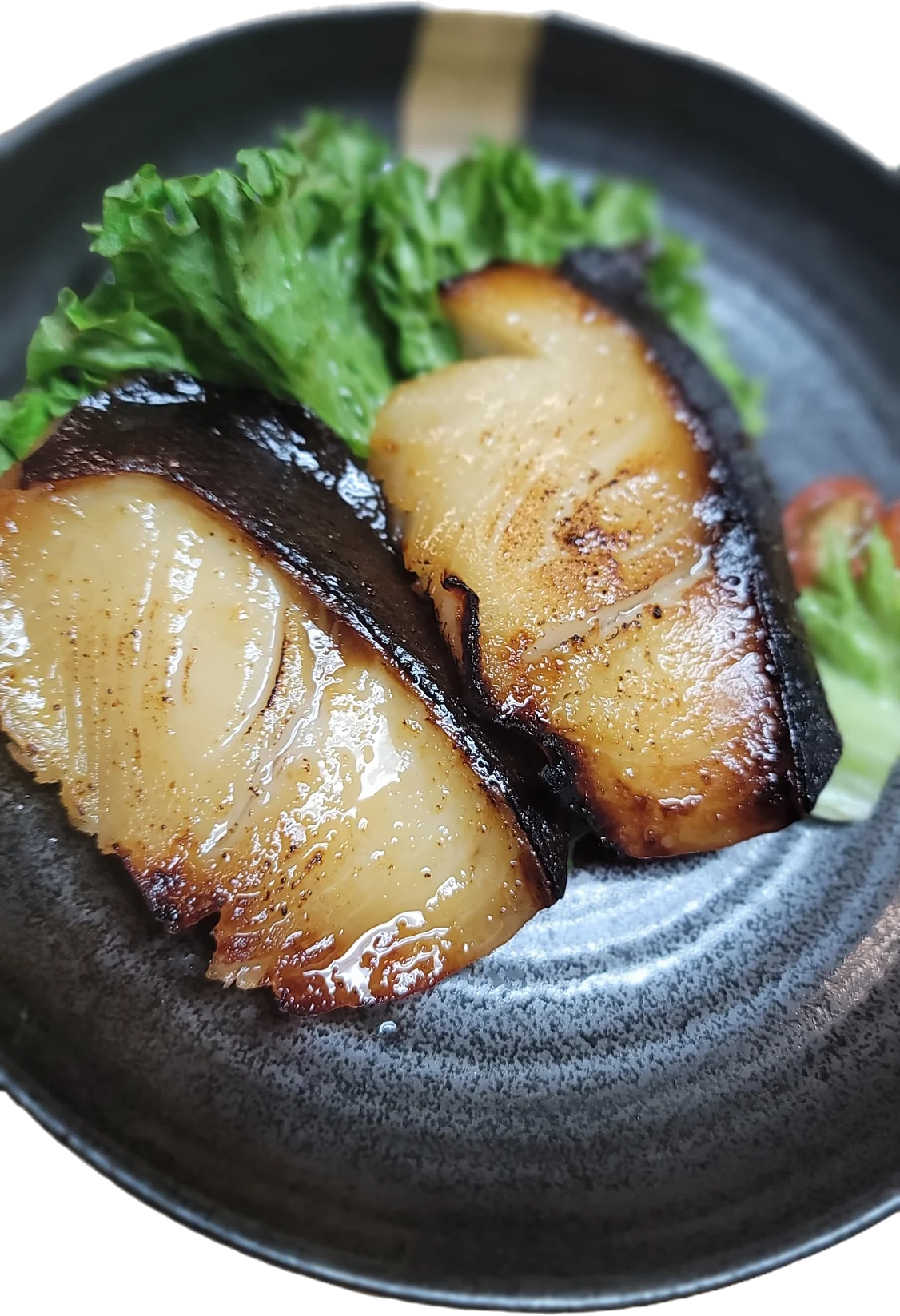 Grilled miso black cod served with lettuce