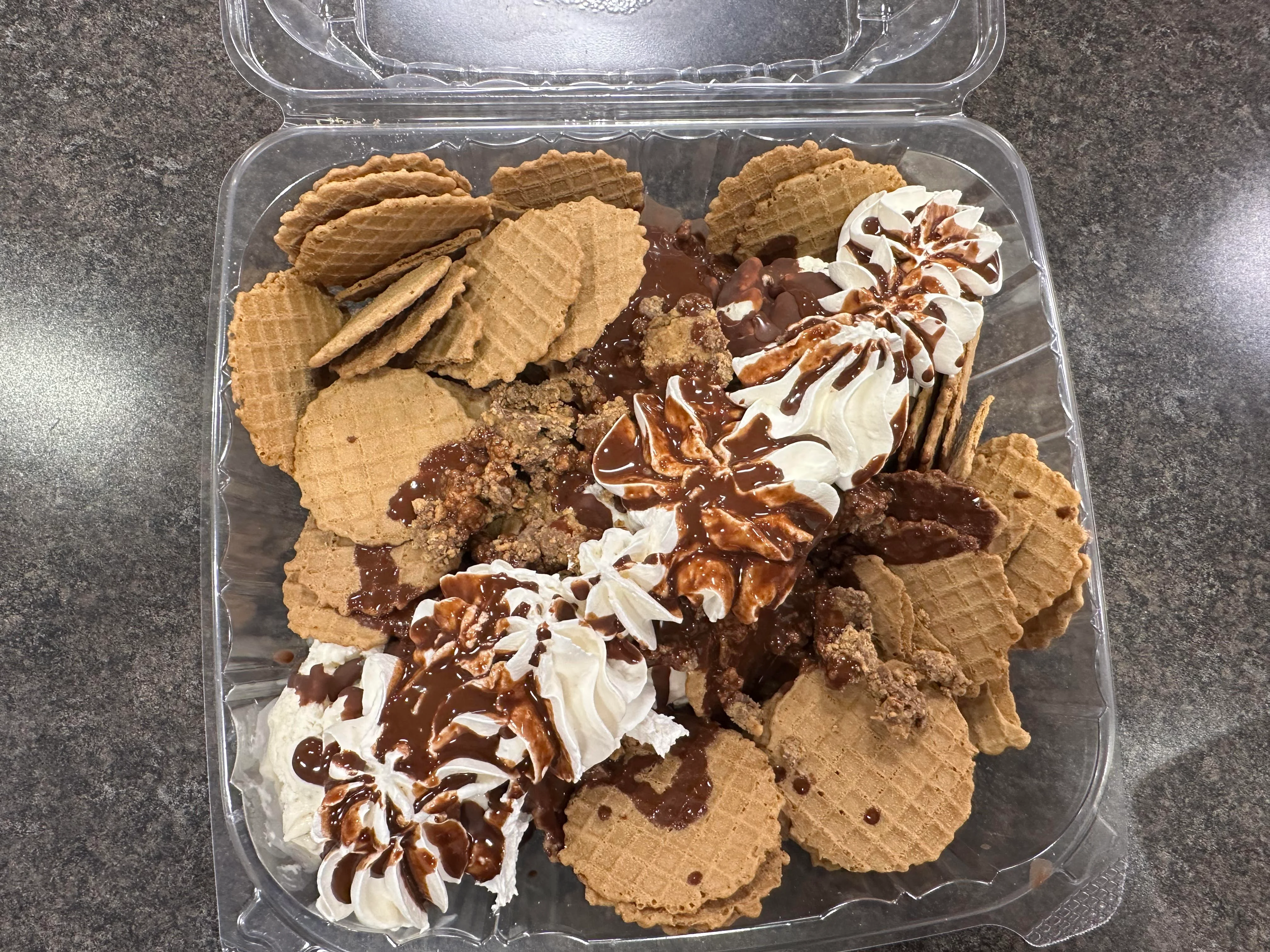Decadent ice cream sundae with waffle cones and whipped cream