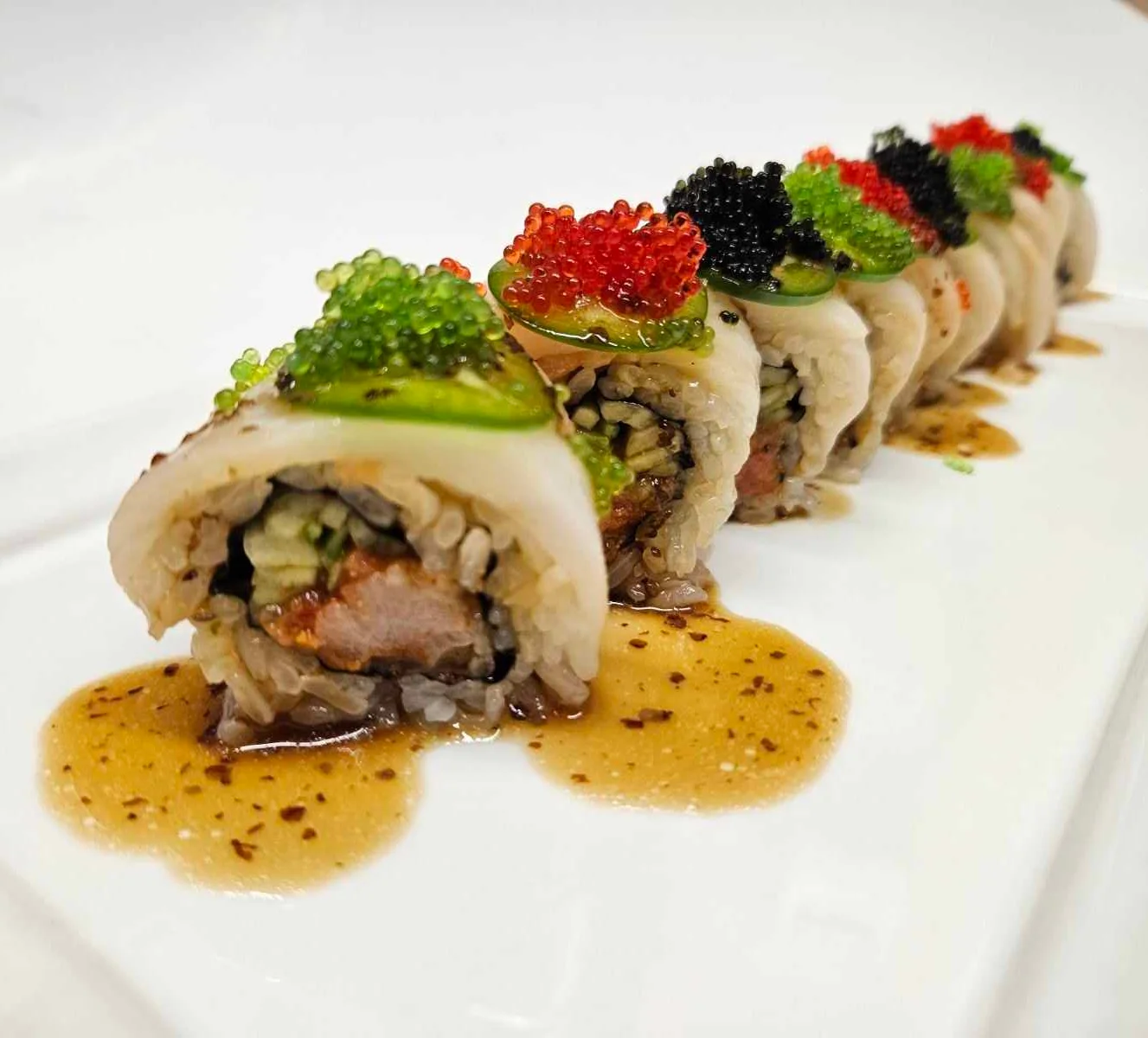 Artfully presented sushi roll with vibrant toppings