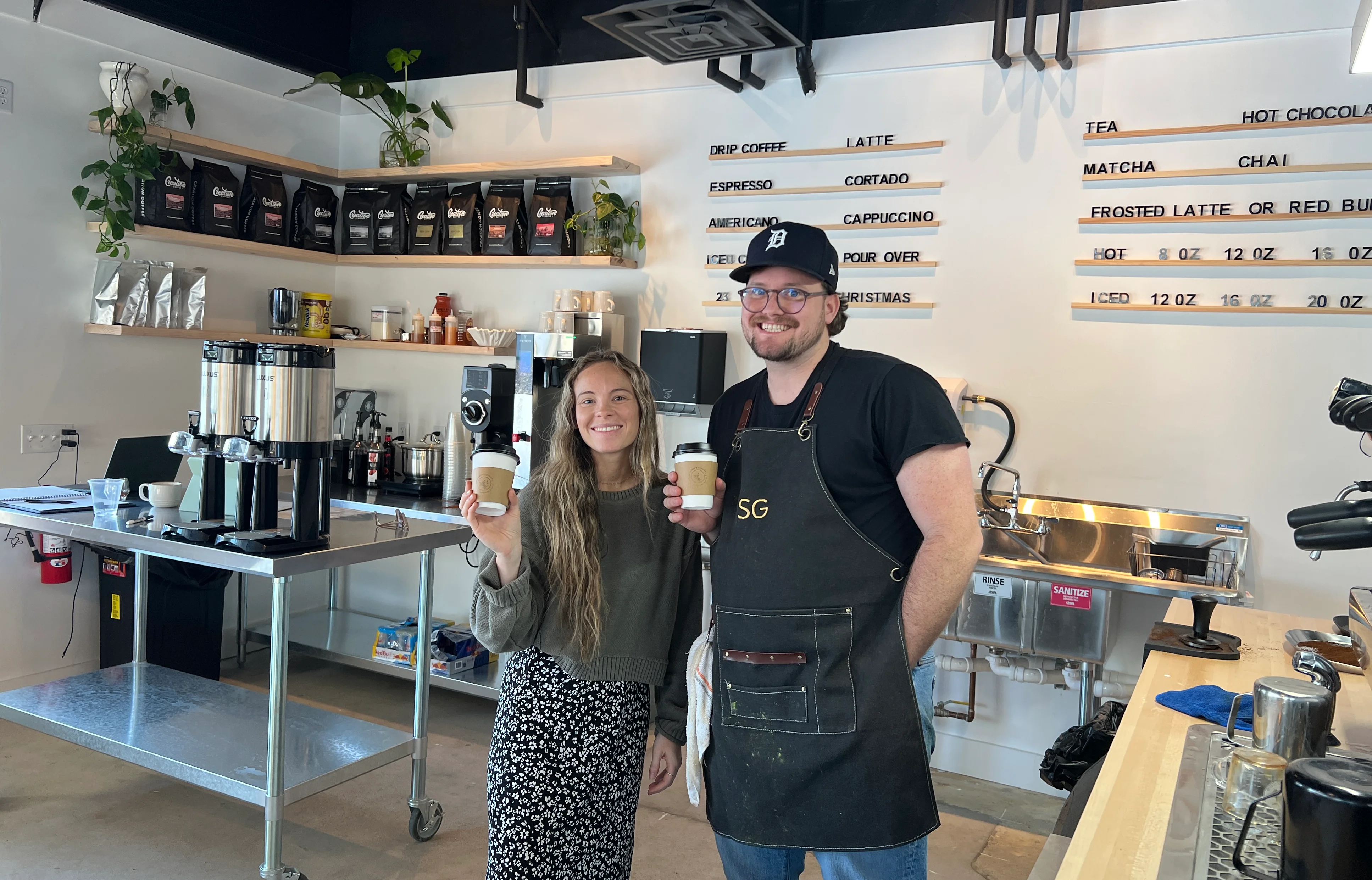Baristas serving coffee in a modern café setting