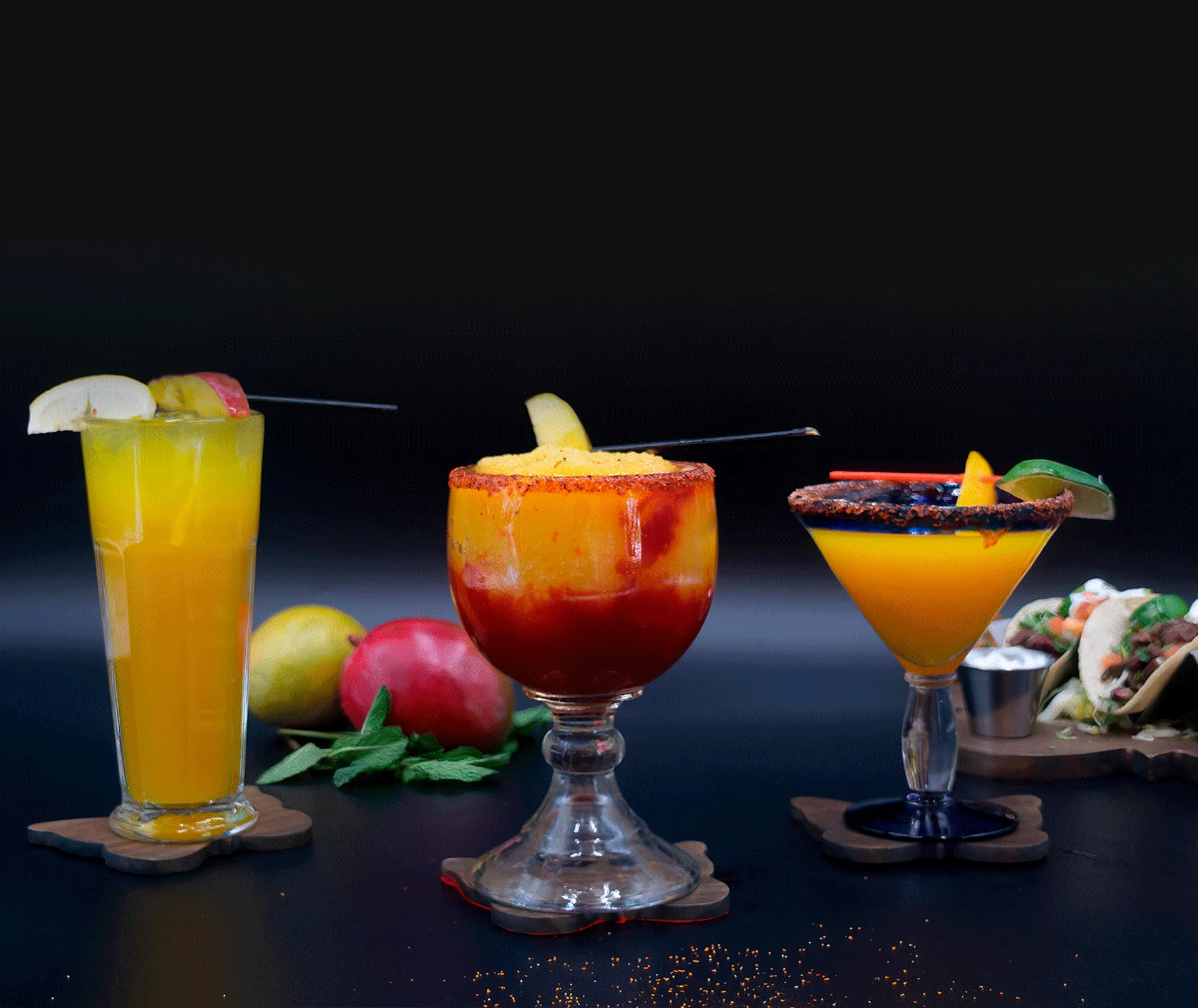 3 tropical drinks with fresh fruit