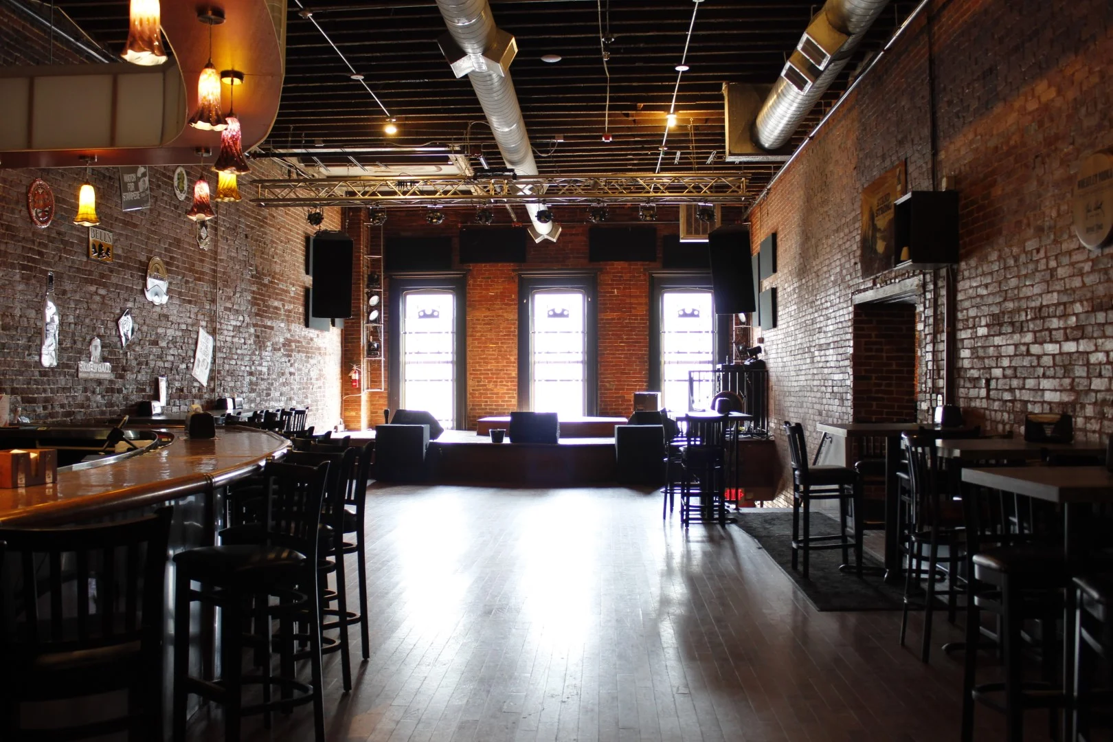 Private event space with stage and bar at Parlour Pizza in New Albany, IN
