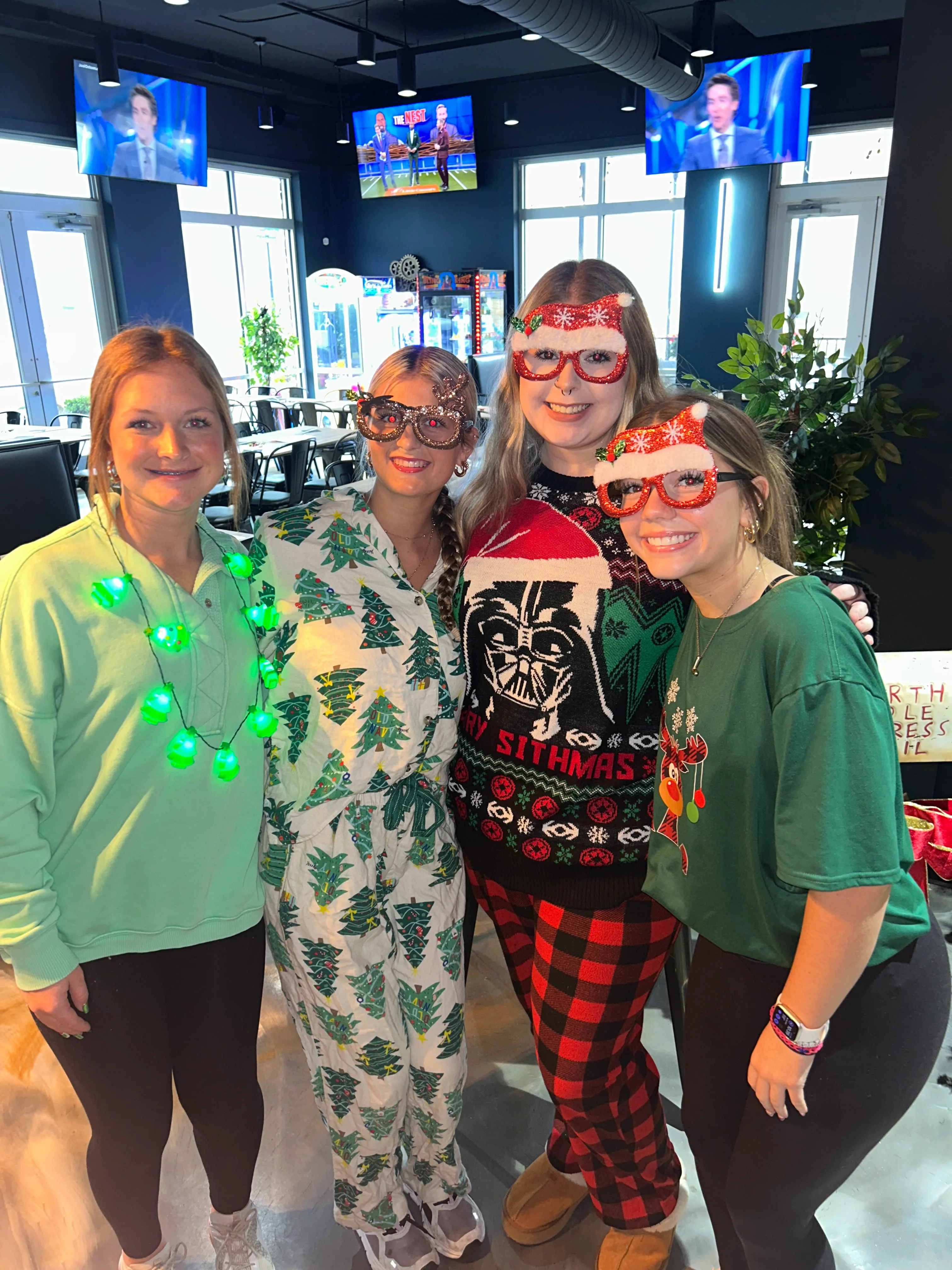 Group of friends in festive attire celebrating the holidays at a restaurant