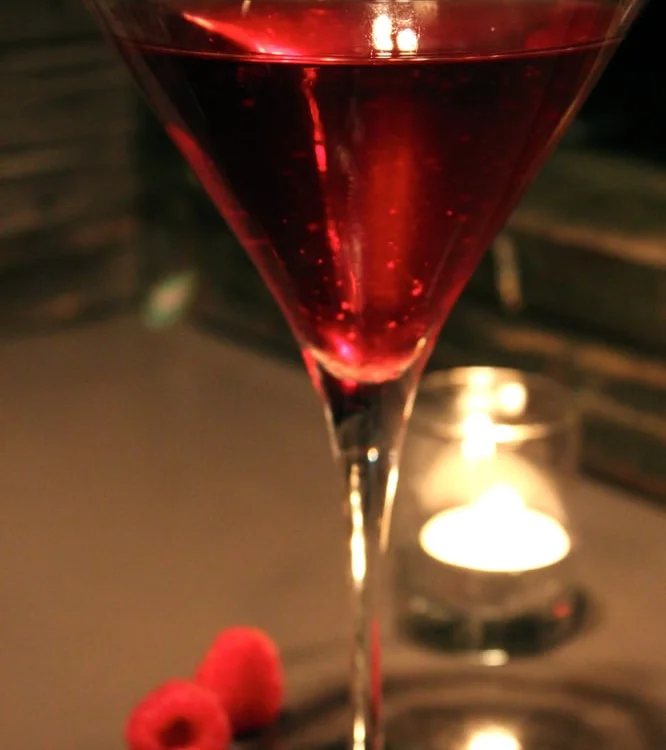 Vibrant raspberry cocktail in a martini glass