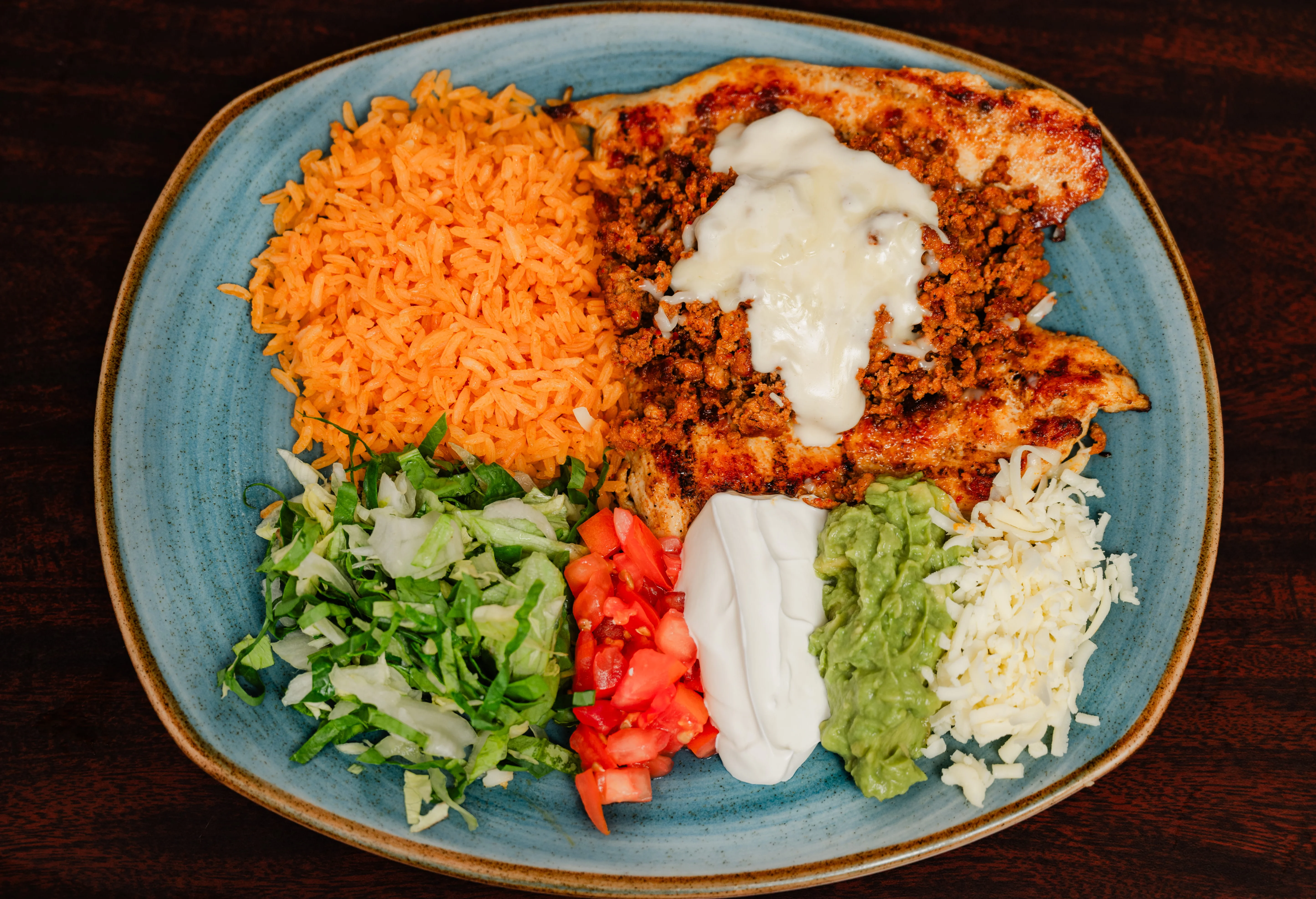Delicious quesadilla slices with salsa and lime on a white plate.
