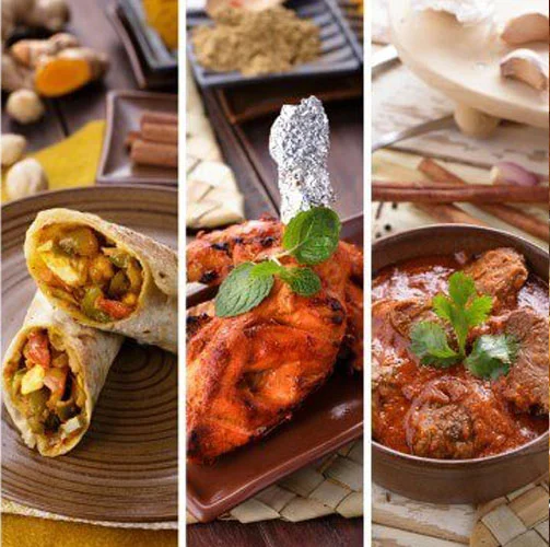 Indian tandoori chicken, kebab wrap, and meat curry in traditional dishes