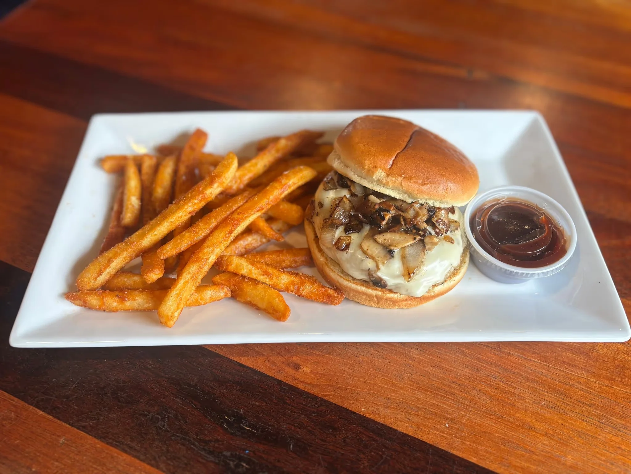 Delicious gourmet burger with fresh toppings on a wooden table