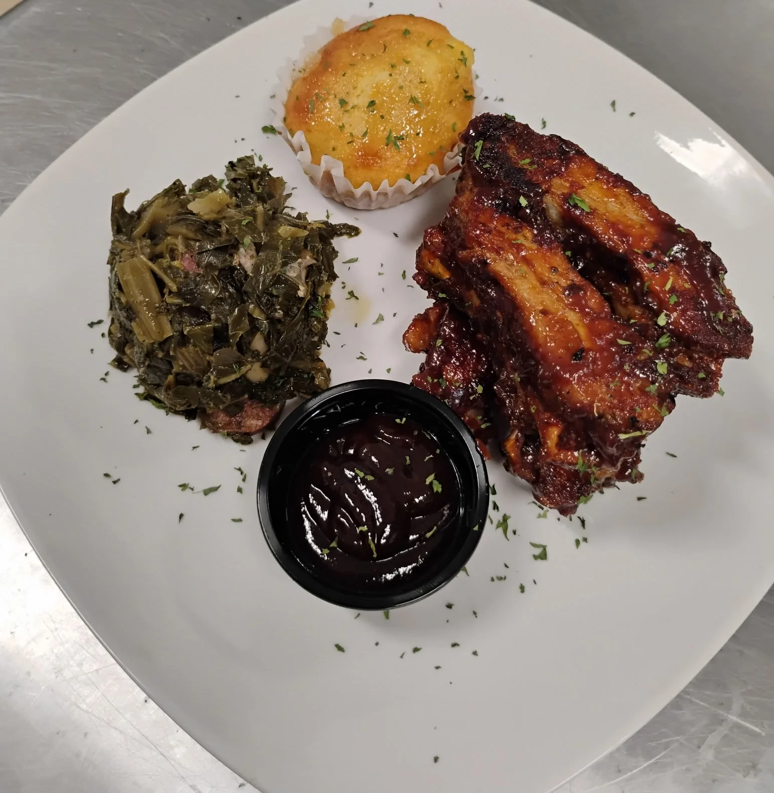 Southern BBQ ribs with cornbread and collard greens