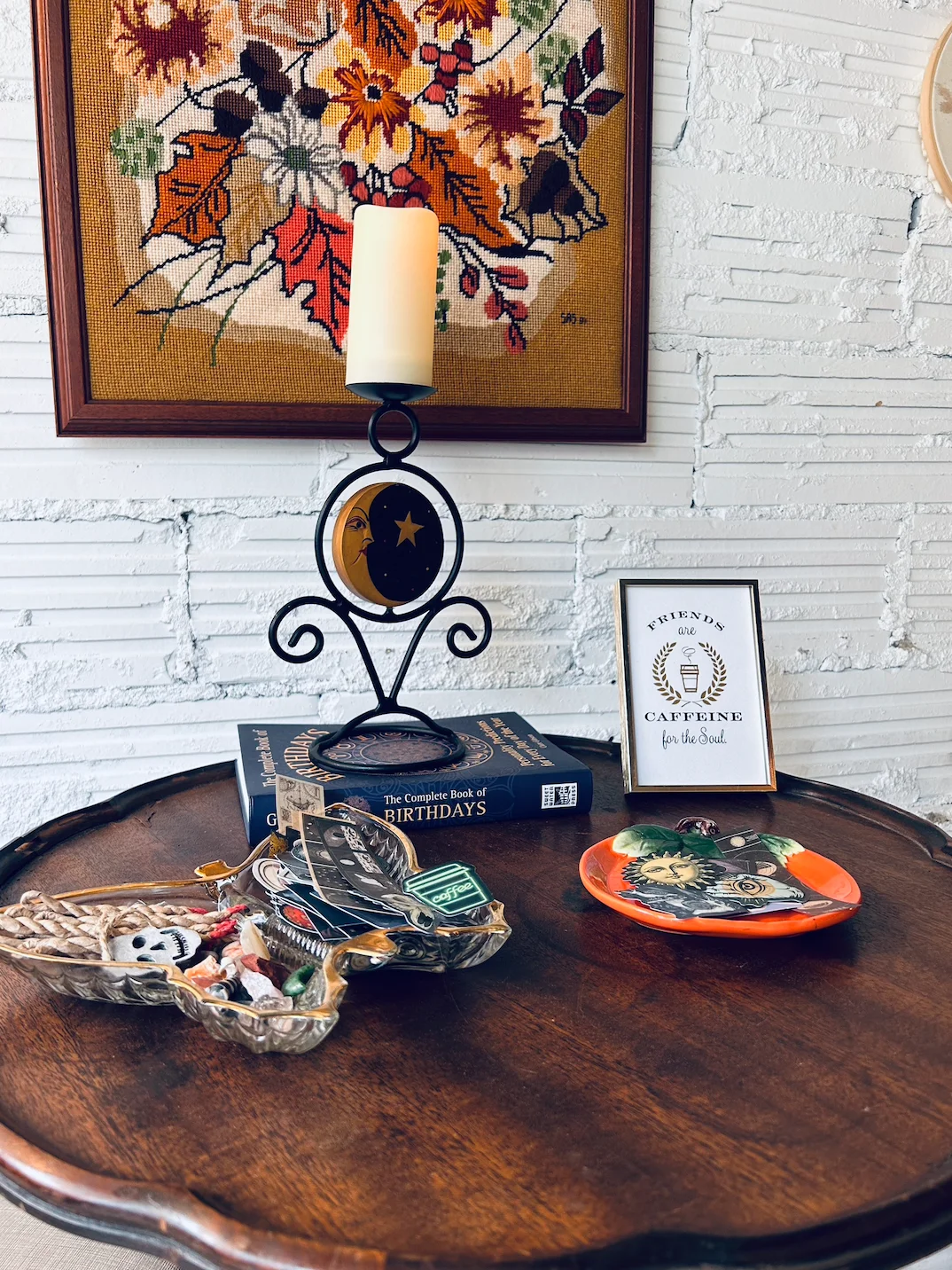 Charming table decor with candle, books, and artistic plates