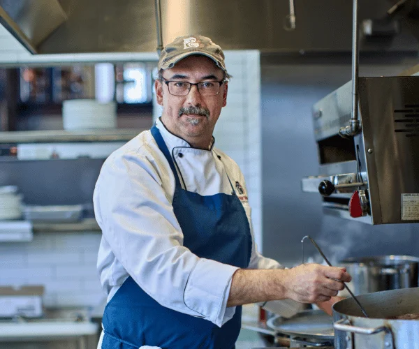 Chef preparing a dish in a modern kitchen