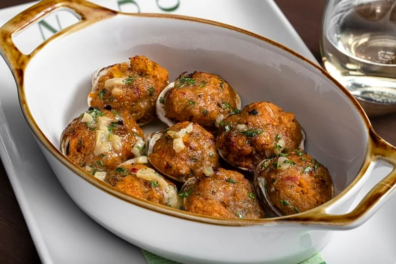 Baked stuffed clams in a ceramic dish