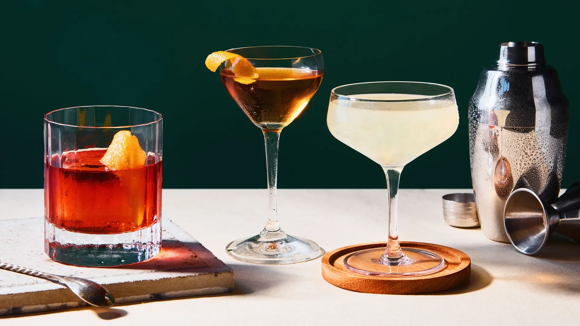 Three elegant cocktails on a bar counter