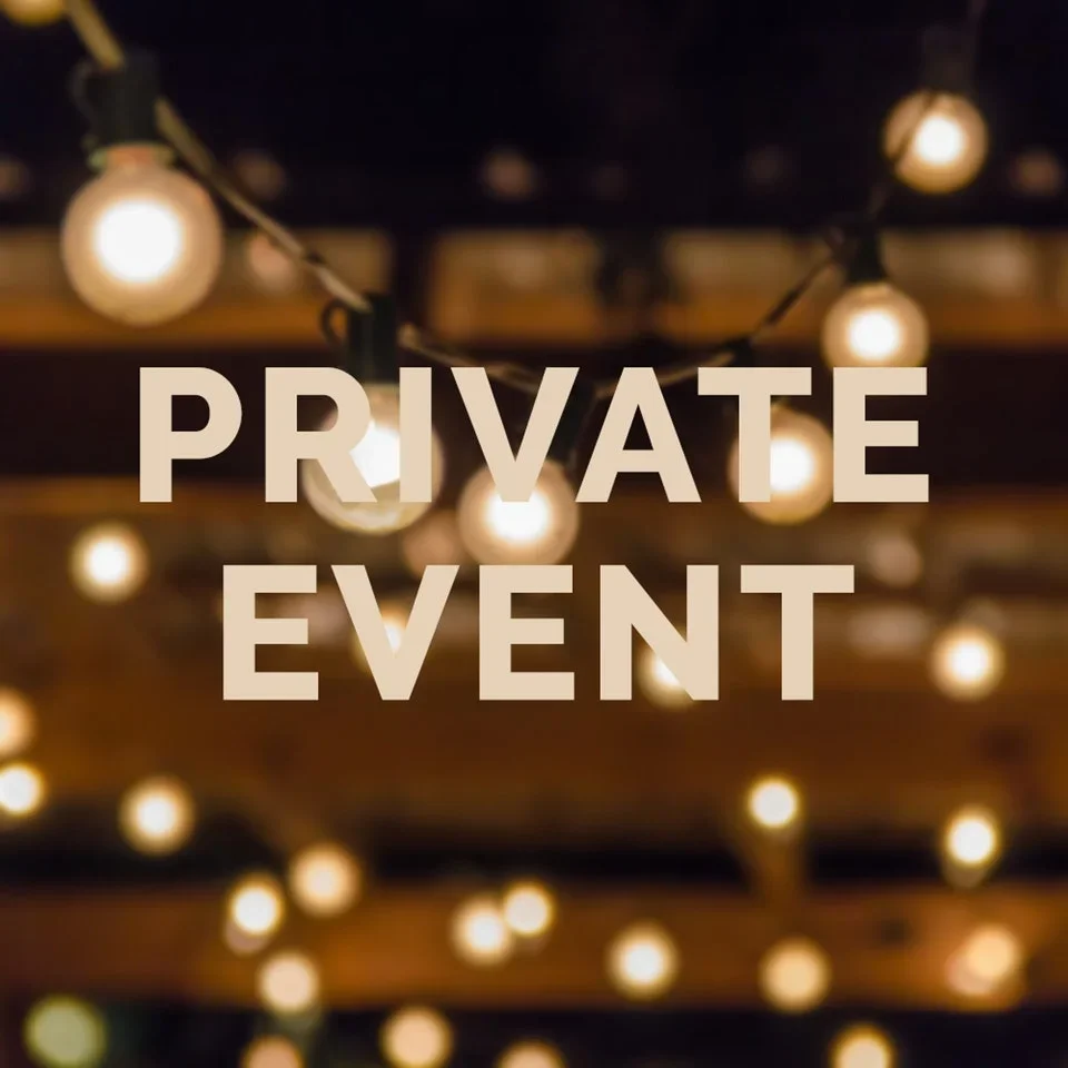 Warmly lit space for a private event with string lights