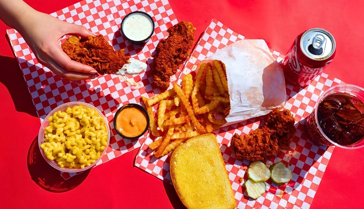 Fried chicken pieces served with crinkle-cut fries, pickles, two slices of toast, and a container of ranch dressing.