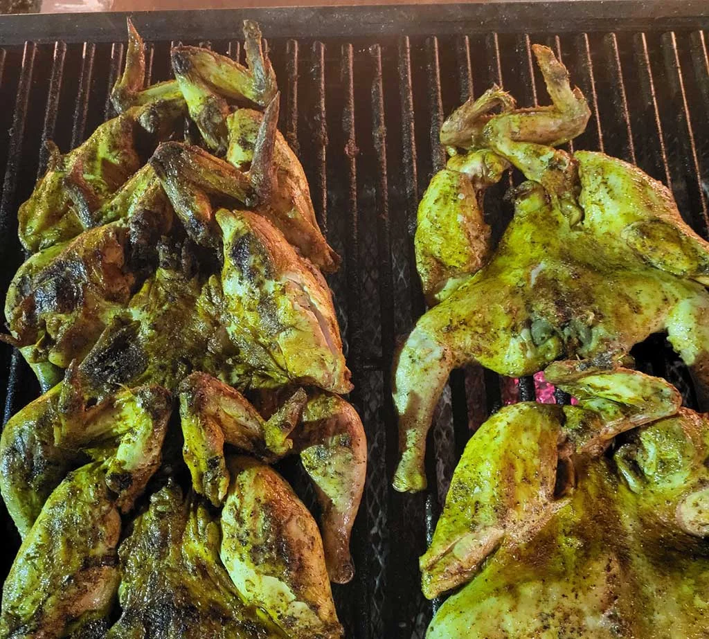 Grilled Peruvian pollo a la brasa on a charcoal grill