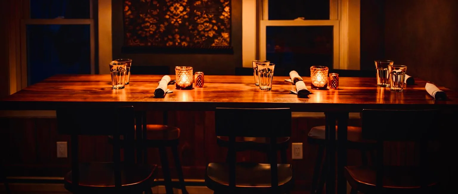 Cozy restaurant interior with warm lighting and wooden table